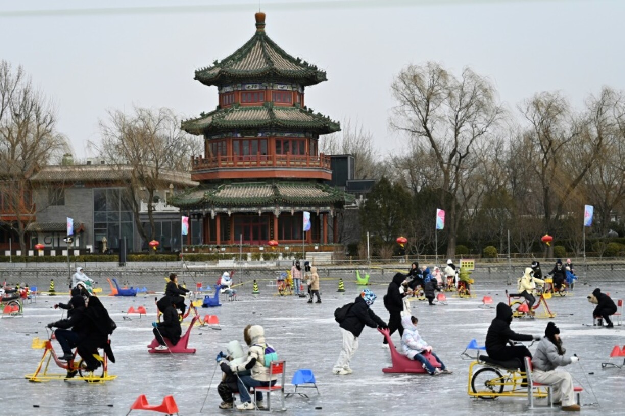 By a frozen lake dotted with ice skaters in Beijing's historic centre, people expressed optimism about the Year of the Snake