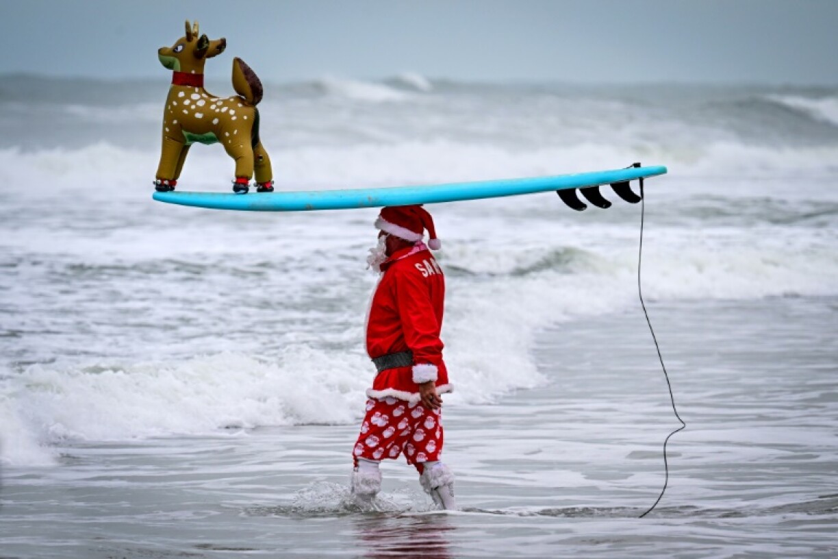The 16th annual 'Surfing Santas' event was held on Christmas Eve in Cocoa Beach, Florida