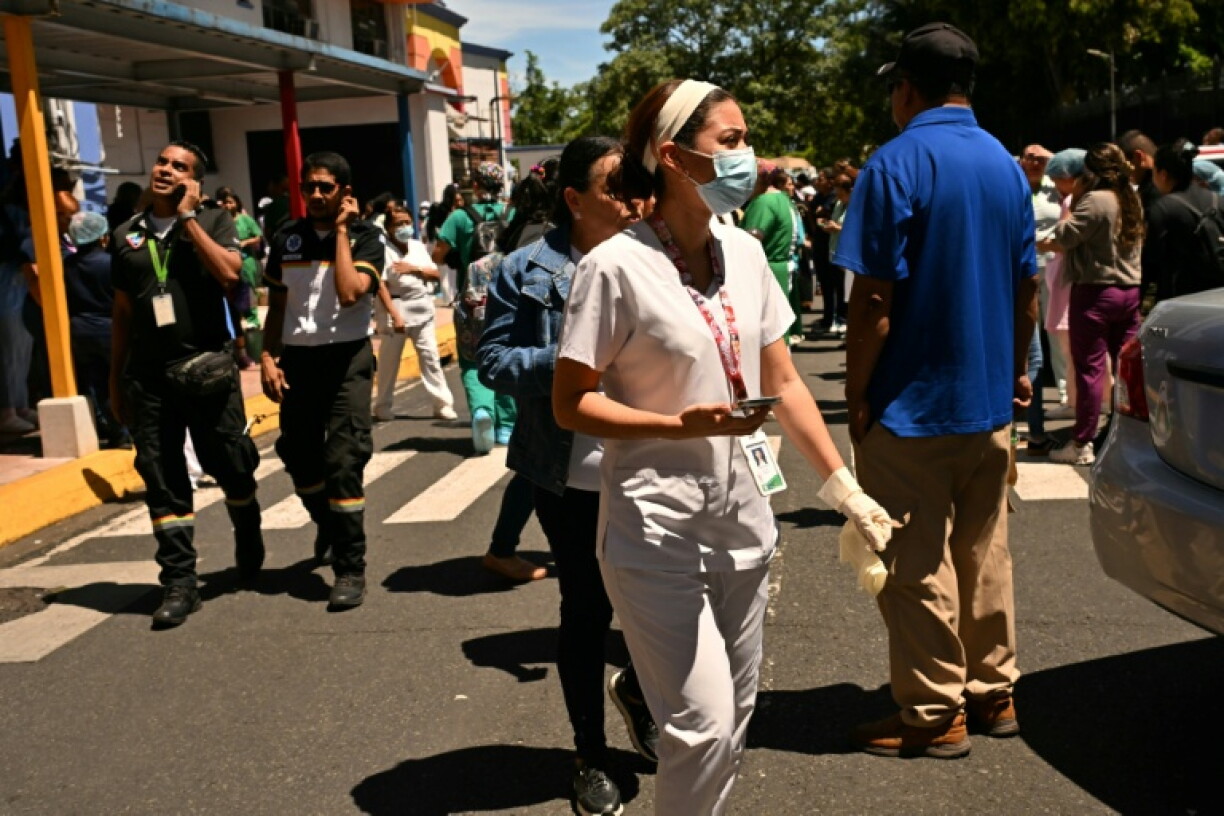 People check their mobile phones outside the maternity ward of Panama City's Santo Tomas hospital, after a 7.6 magnitude earthquake hit the country