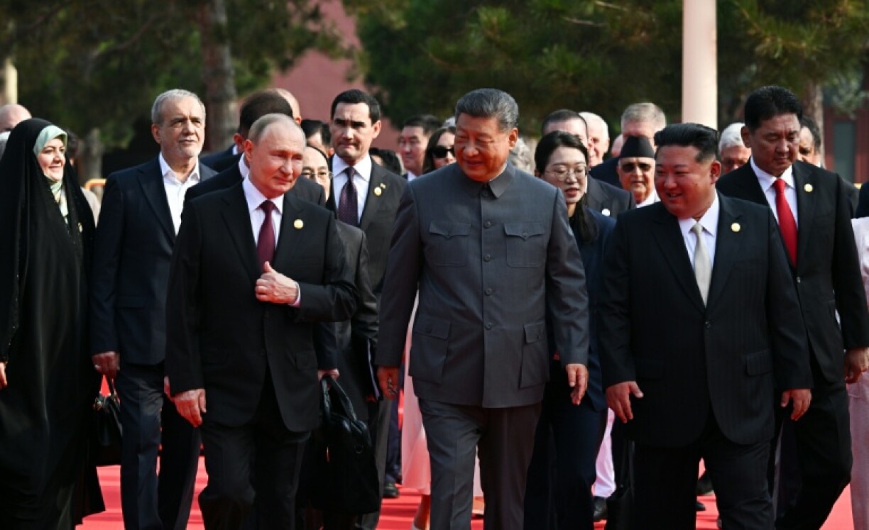 (L-R) Russia's President Vladimir Putin walks with China's President Xi Jinping and North Korea's leader Kim Jong Un before a military parade marking the 80th anniversary of victory over Japan and the end of World War II