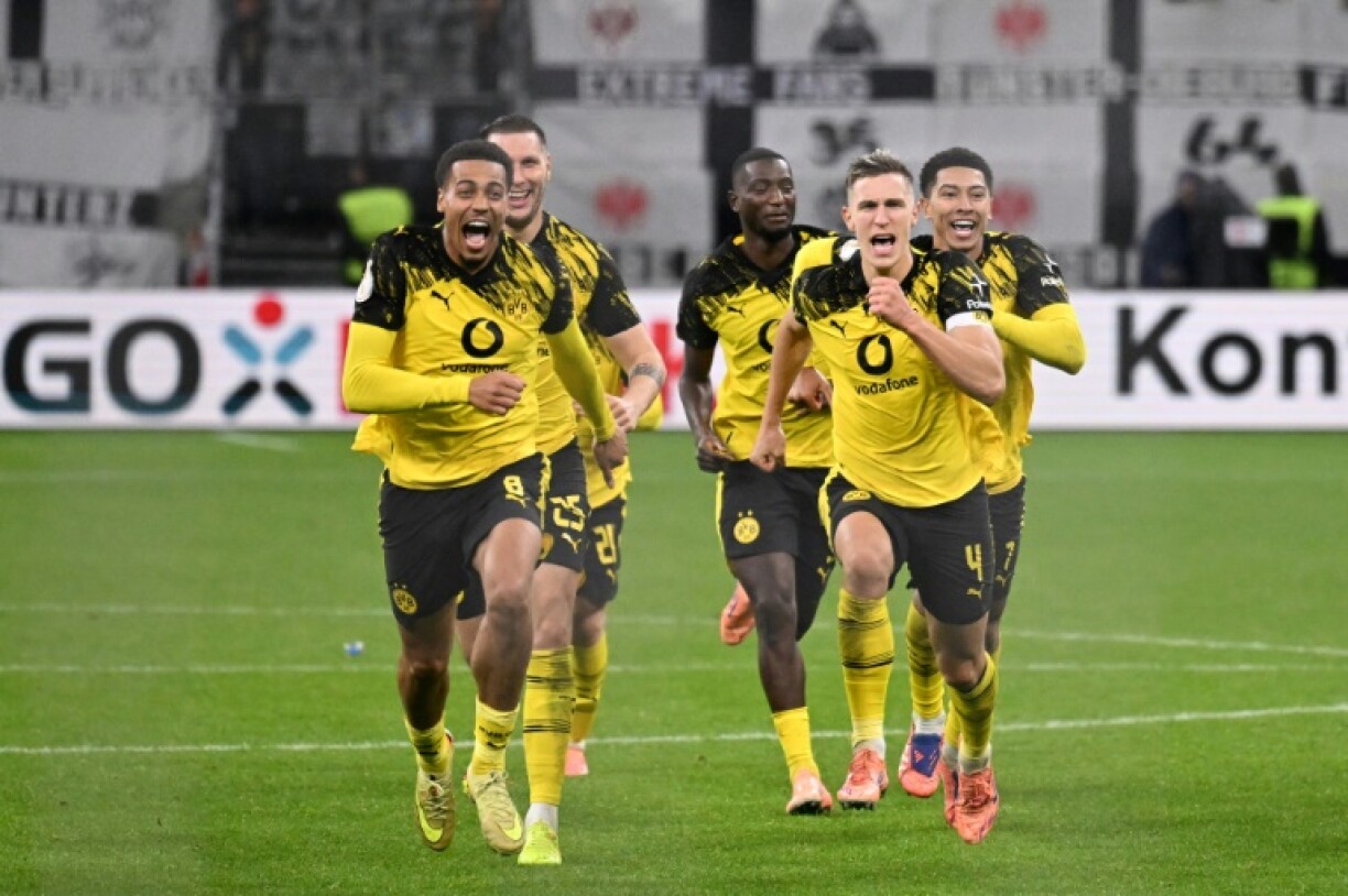 Borussia Dortmund players celebrate after knocking Eintracht Frankfurt out of the German Cup on penalties