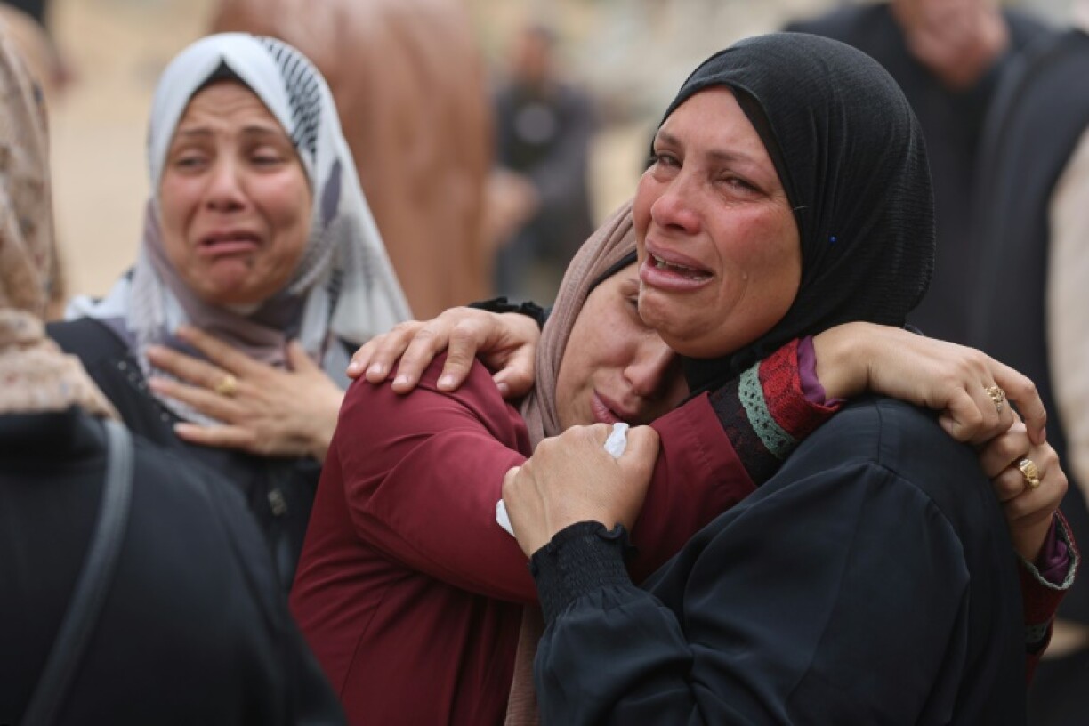 Palestinians mourn during a funeral of relatives killed in an Israeli strike on a school-turned-shelter at the Al-Shifa hospital in Gaza City