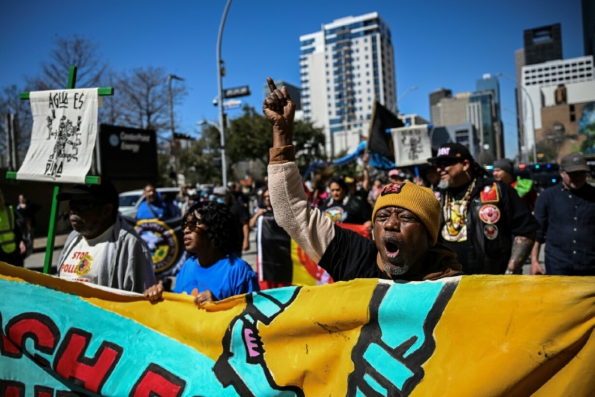 Demonstrators protest outside a major energy conference in Houston, Texas, where officials from Donald Trump's administration vowed to adjust federal policy to favor fossil fuels over climate change initiatives