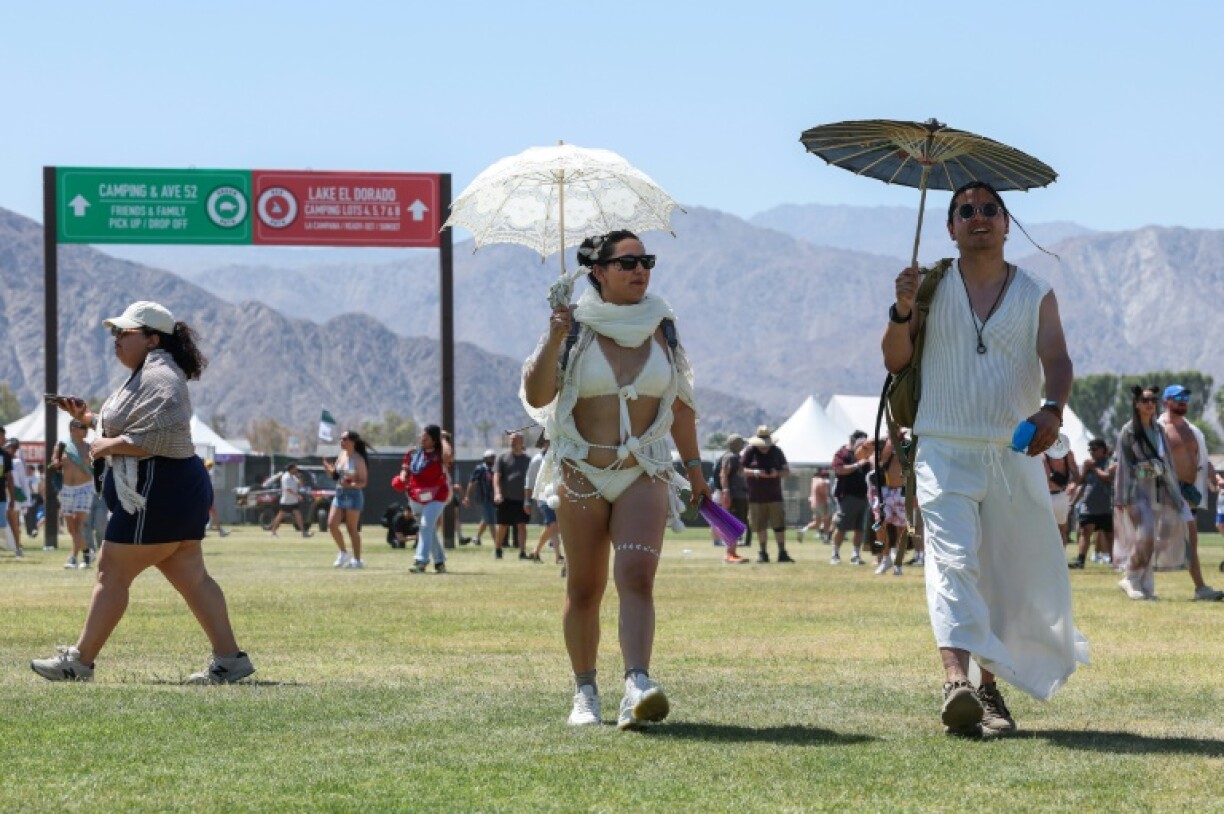 Thousands of music fans traversed the sprawling grounds whipping paper fans and wielding parasols, as temperatures cracked the 100-degree Fahrenheit mark (37.8 degrees Celsius)