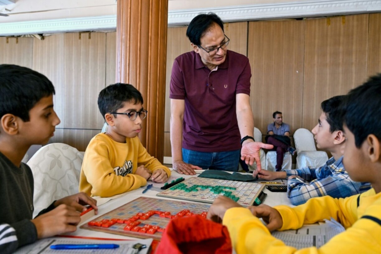 Pakistan Scrabble Association youth programme director Tariq Pervez gives direction to youngsters competing in a Scrabble championship organised in Karachi