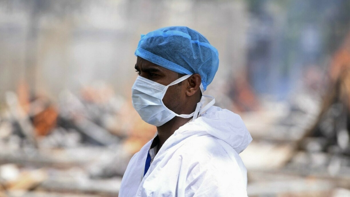 A relative of a victim who died due to the Covid-19 coronavirus stands at a cremation ground in New Delhi on May 4, 2021, as India's total Covid caseload soared past 20 million.