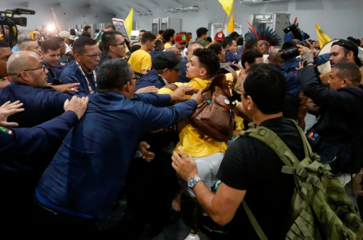 Security personnel clash with indigenous people and students as they storm the venue during the COP30 UN Climate Change Conference in Belem, Para State, Brazil, on November 11, 2025