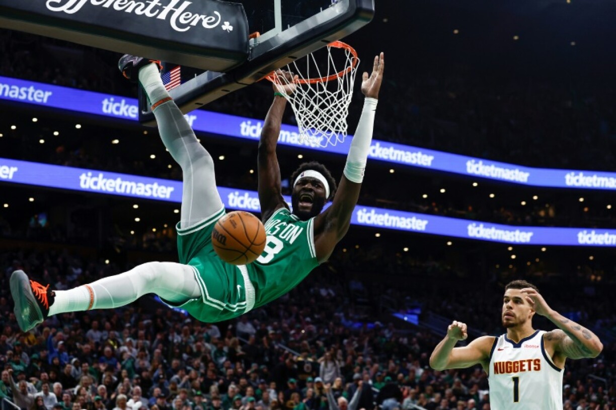 Boston's Neemias Queta screams out after dunking as Michael Porter Jr. looks on in the Celtics' NBA win over the Denver Nuggets