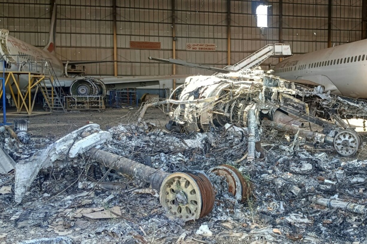 The charred remains of an aircraft are scattered in a hangar at Khartoum's airport -- among key facilities recaptured by Sudan's army in the city centre