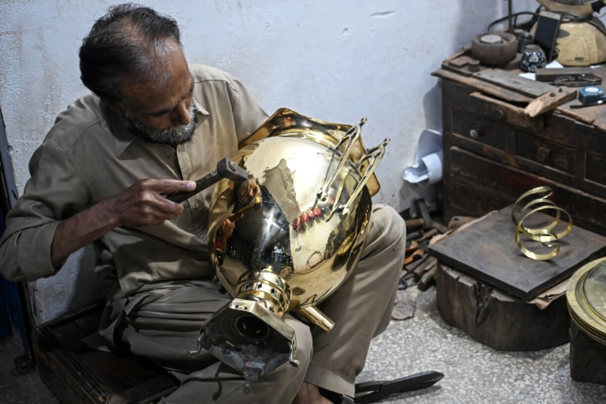 Restorer Shakeel Ahmed works on an antique at his workshop in Rawalpindi