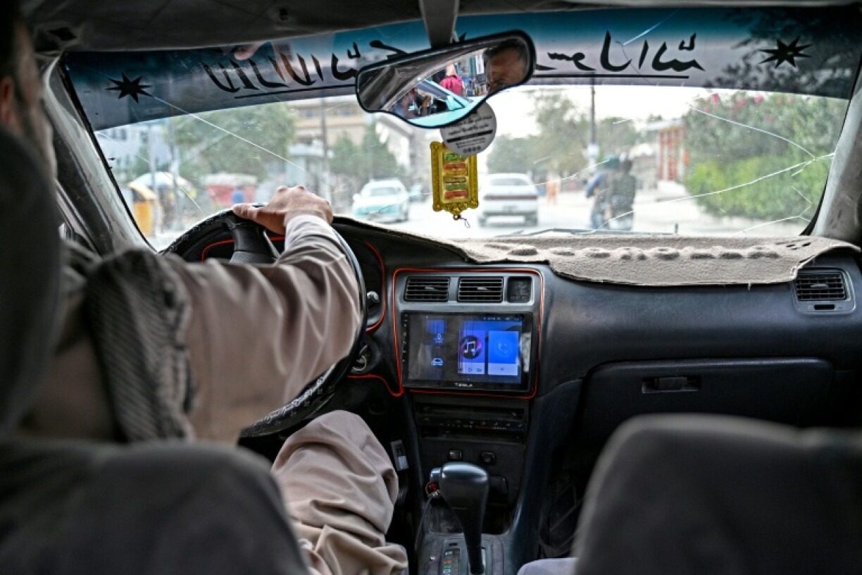 A radio can be seen in an taxi transporting passengers in Kabul