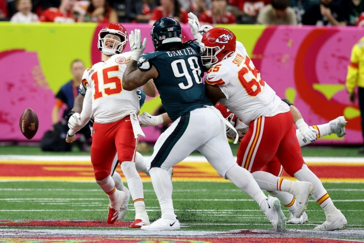 The Philadelphia Eagles' Milton Williams forces a fumble by Chiefs quarterback Patrick Mahomes