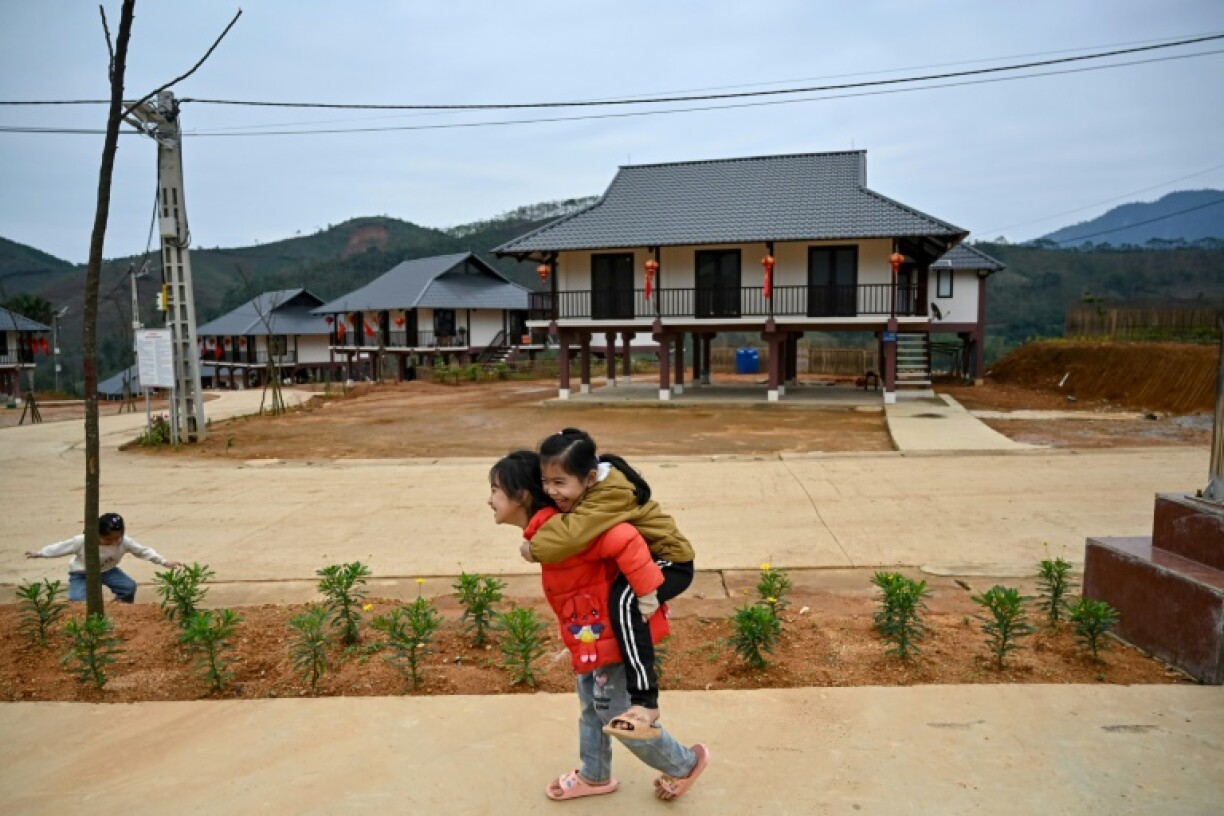 Children playing in the street at the new site of Lang Nu village that authorities hope will withstand future climate change-linked disasters