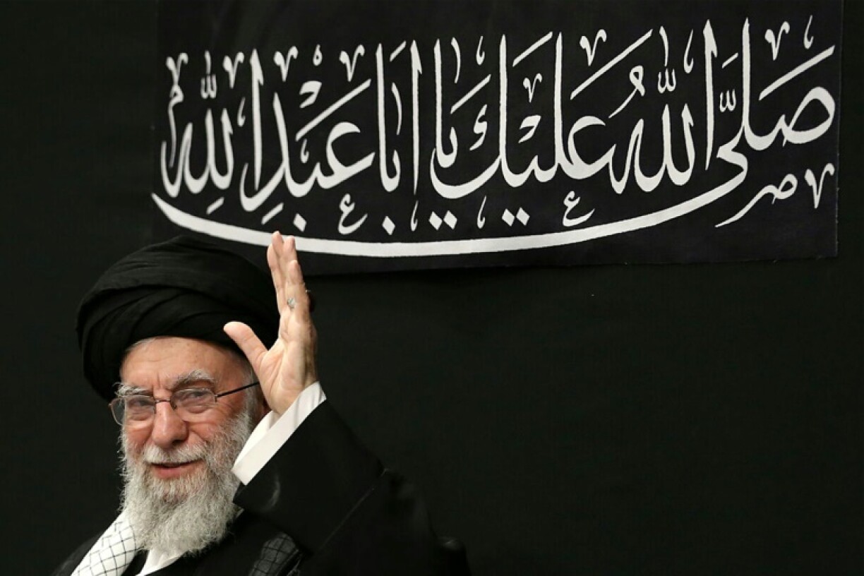 Iran's supreme leader Ayatollah Ali Khamenei waves to the audience in this handout picture released by his office