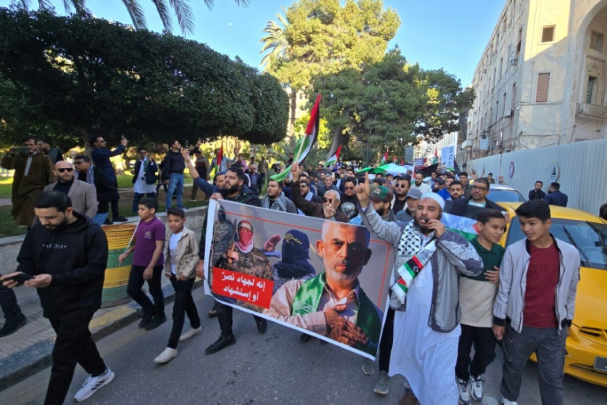 Libyans carry a poster showing slain Hamas leader Yahya Sinwar (R) during a demonstration in solidarity with the Palestinian people, on April 8, 2025 in Tripoli