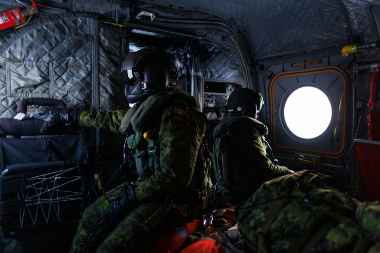 A Canadian soldier looks out the window of a CH-147F Chinook helicopter during Operation Nanook, the Canadian Armed Forces' annual Arctic training exercise near Inuvik, Canada in March 2025