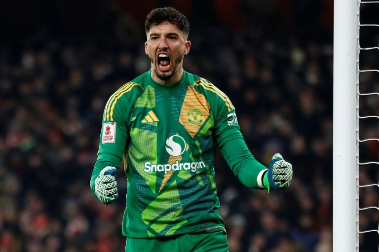 Manchester United goalkeeper Altay Bayindir celebrates after saving Kai Havertz's penalty