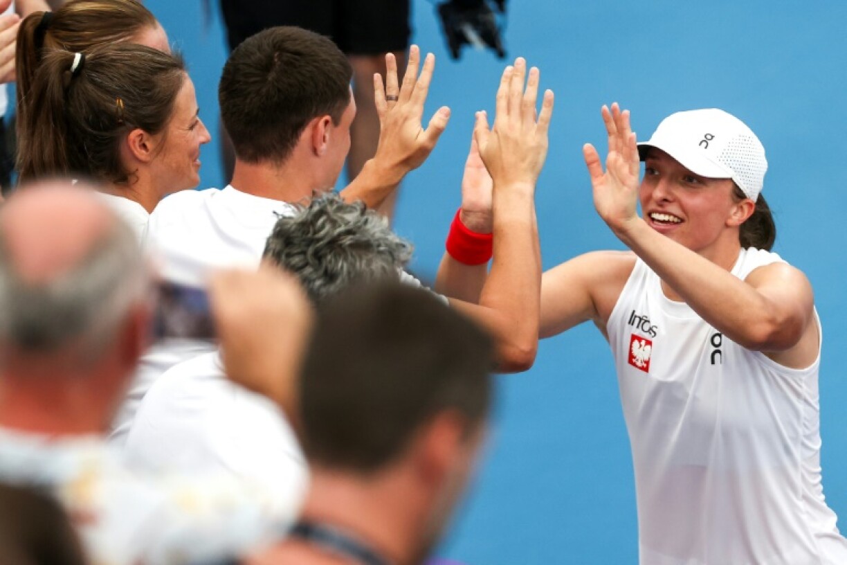 Poland’s Iga Swiatek (R) celebrates with teammates at the United Cup