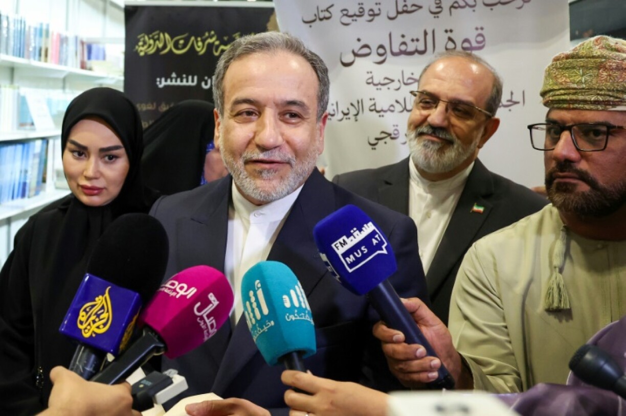 Iran's Foreign Minister Abbas Araghchi speaks to reporters at the Muscat International Book Fair ahead of nuclear talks with US officials