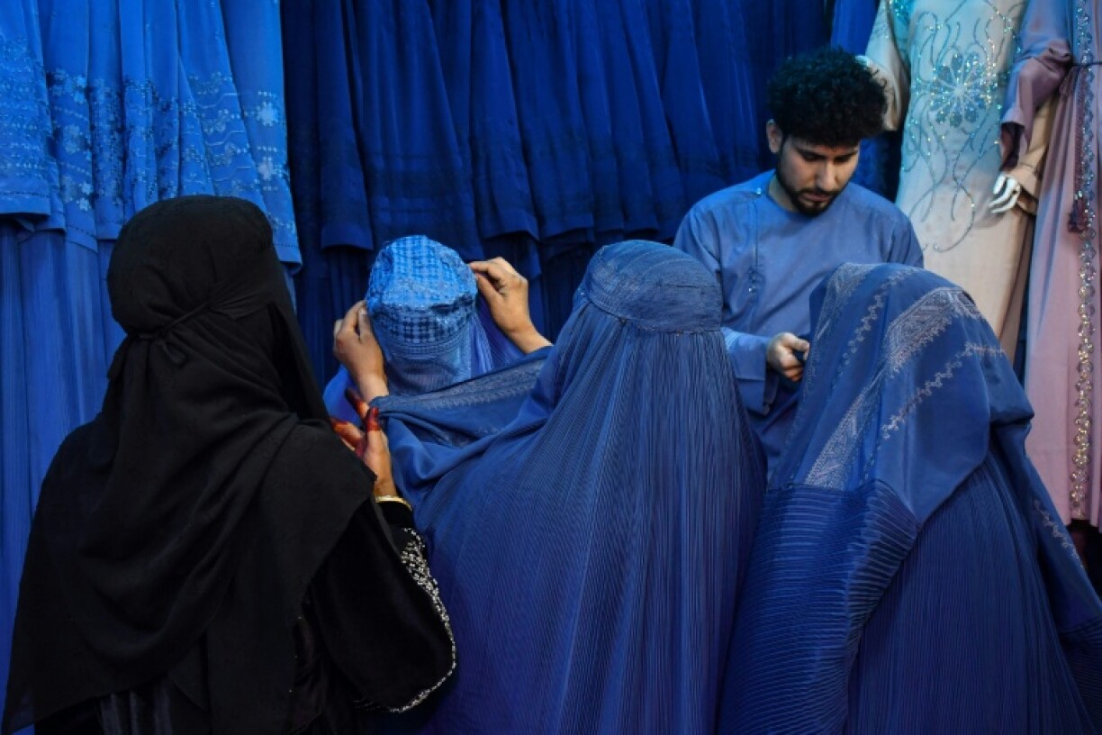 Afghan women buy burqas at a shop in Mazar-i-Sharif. When the Taliban recaptured Kabul in 2021, they had promised to be more flexible than during their first rule
