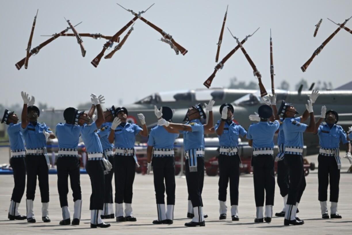 Indian Air force cadets toss their rifles during a full dress rehearsal ahead of MIG-21 Bison fighter jet farewell at Chandigarh Airforce Station on September 24, 2025