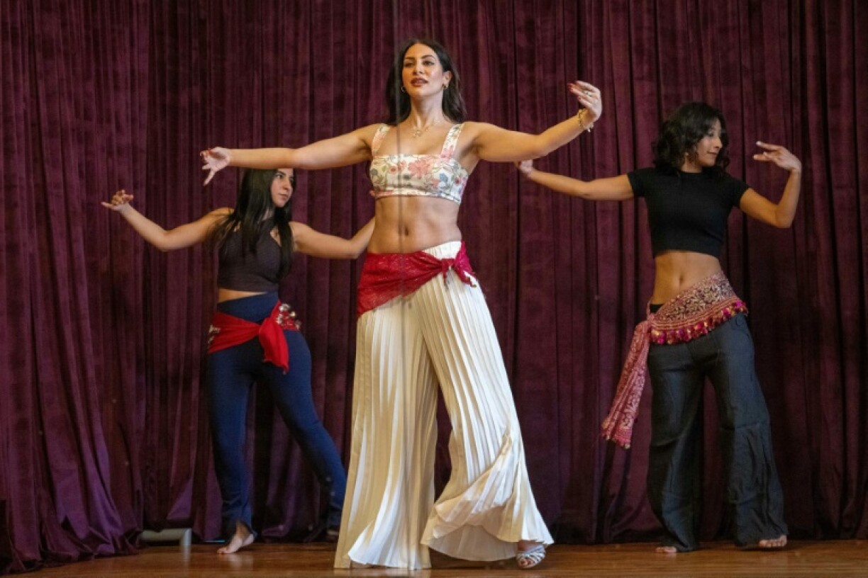 Sultan (C) and fellow dancers Safaa Saeed (L) and Menna Emmam (R) rehearse at a dance studio in Cairo