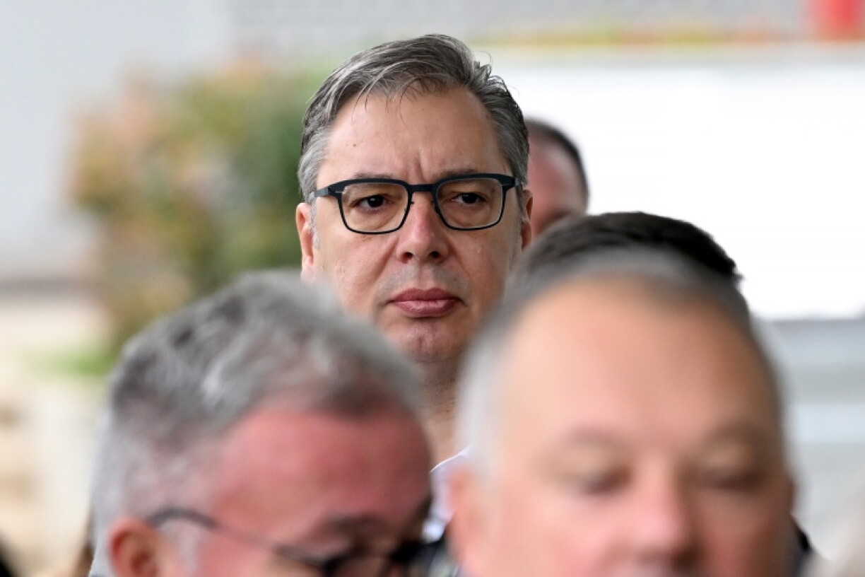 Former Serbian president Aleksandar Vucic (C), the Serbian Progressive Party (SNS) candidate for prime minister, waits in line to cast his ballot