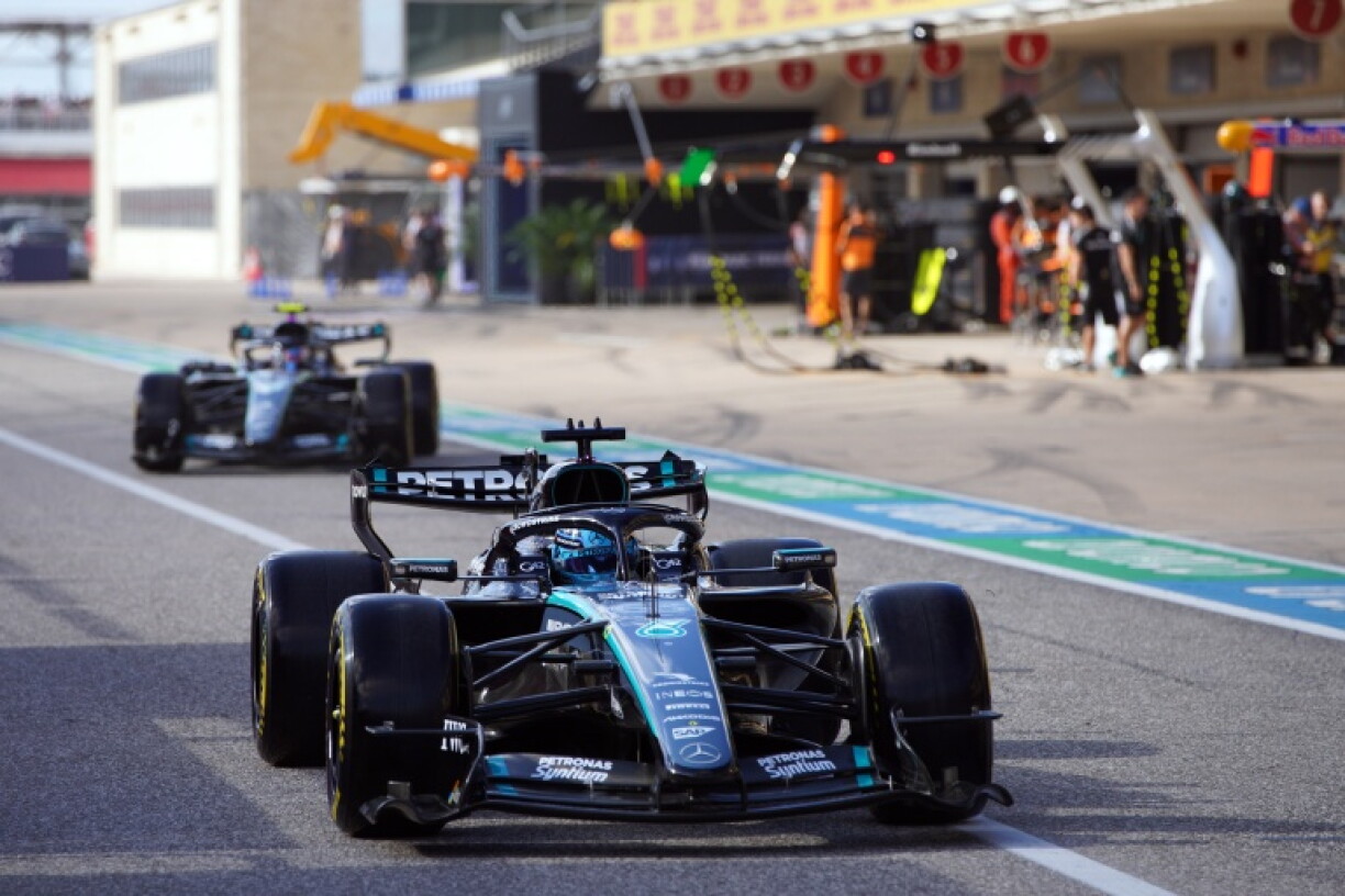 Mercedes' George Russell (R) and Kimi Antonelli exit the pits