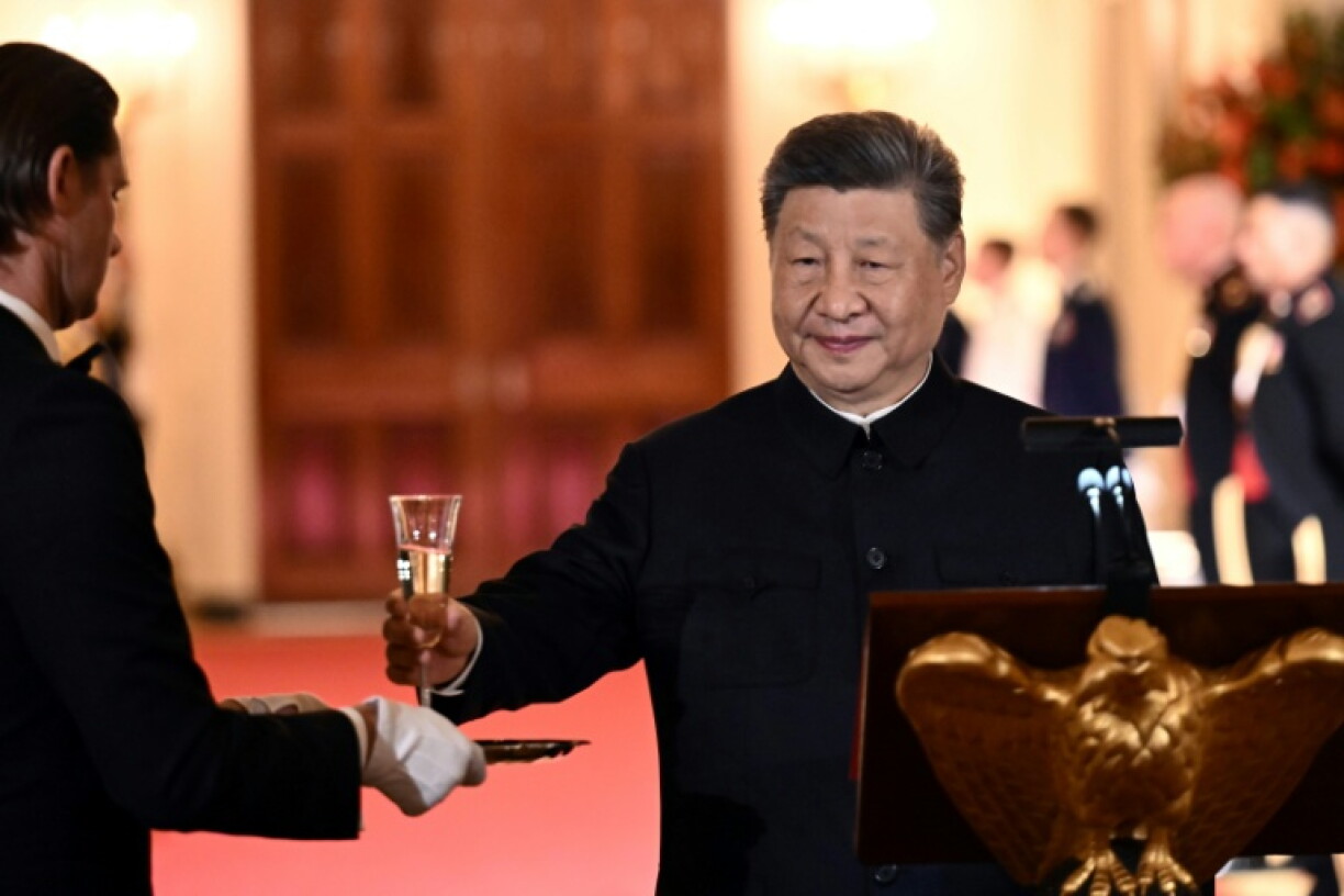 China's President Xi Jinping takes a glass to propose a toast during the State Dinner
