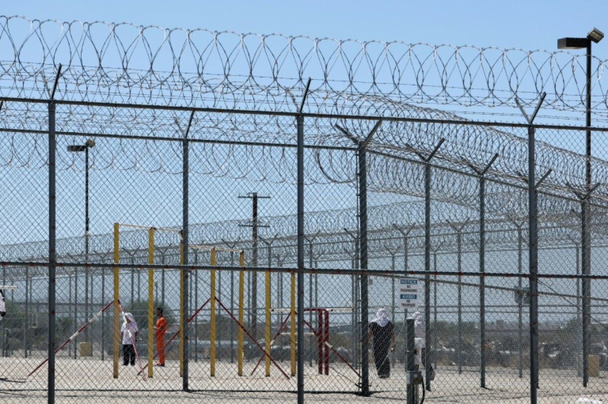 Detainees are seen behind fences at the private GEO Group Adelanto ICE Processing Center detention facility in Adelanto, California on July 10, 2025
