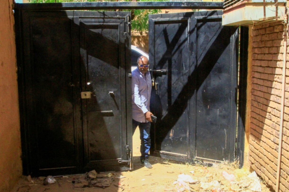 Abdelmoneim Abu Idris Ali enters his home for the first time in two years after fleeing Khartoum