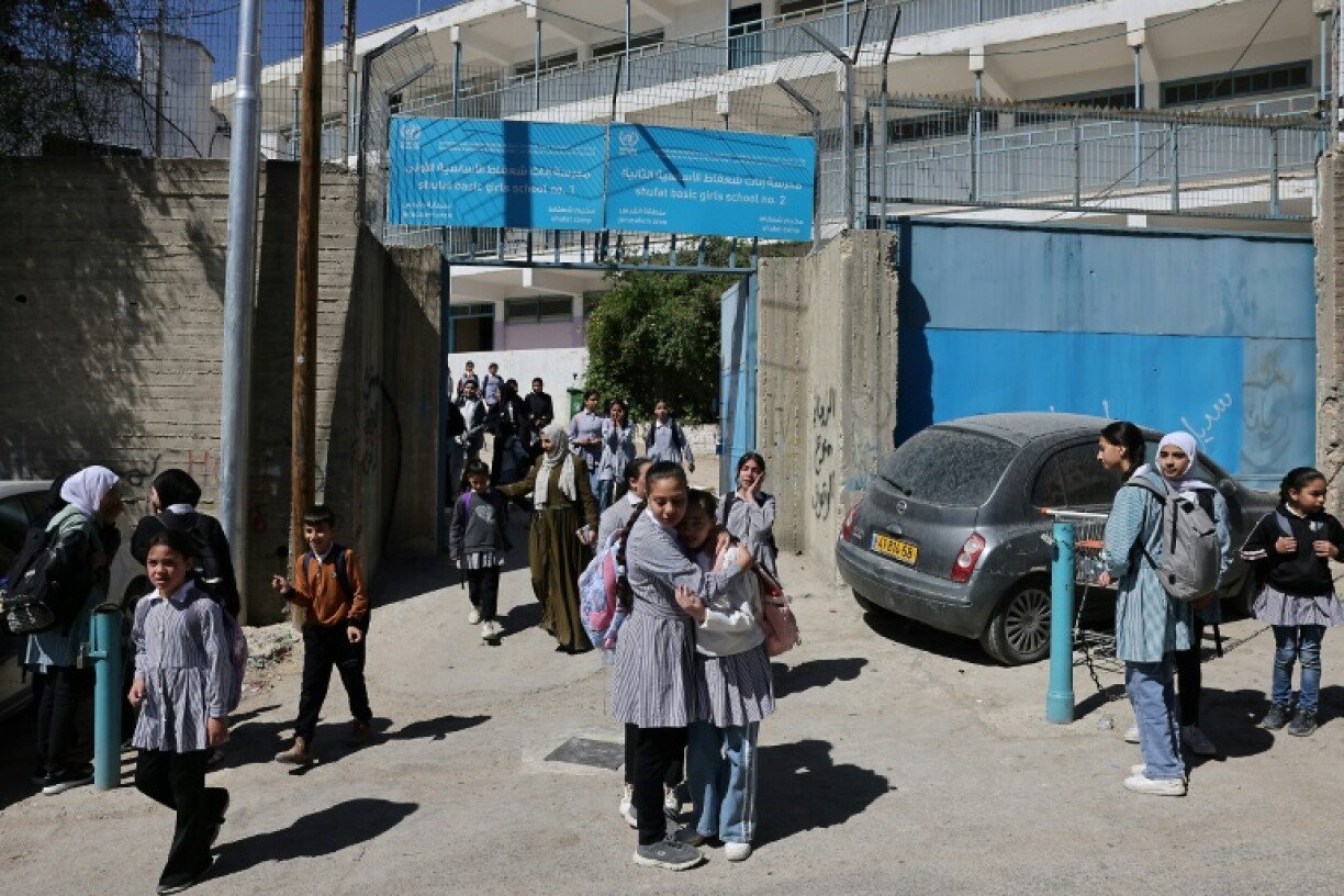 Palestinian schoolgirls leave a UNWRA school in the Shuafat refugee camp