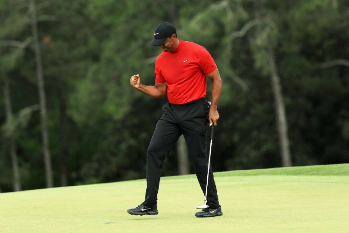 Tiger Woods celebrates after sinking his putt at the 18th to win he 2019 Masters at Augusta National