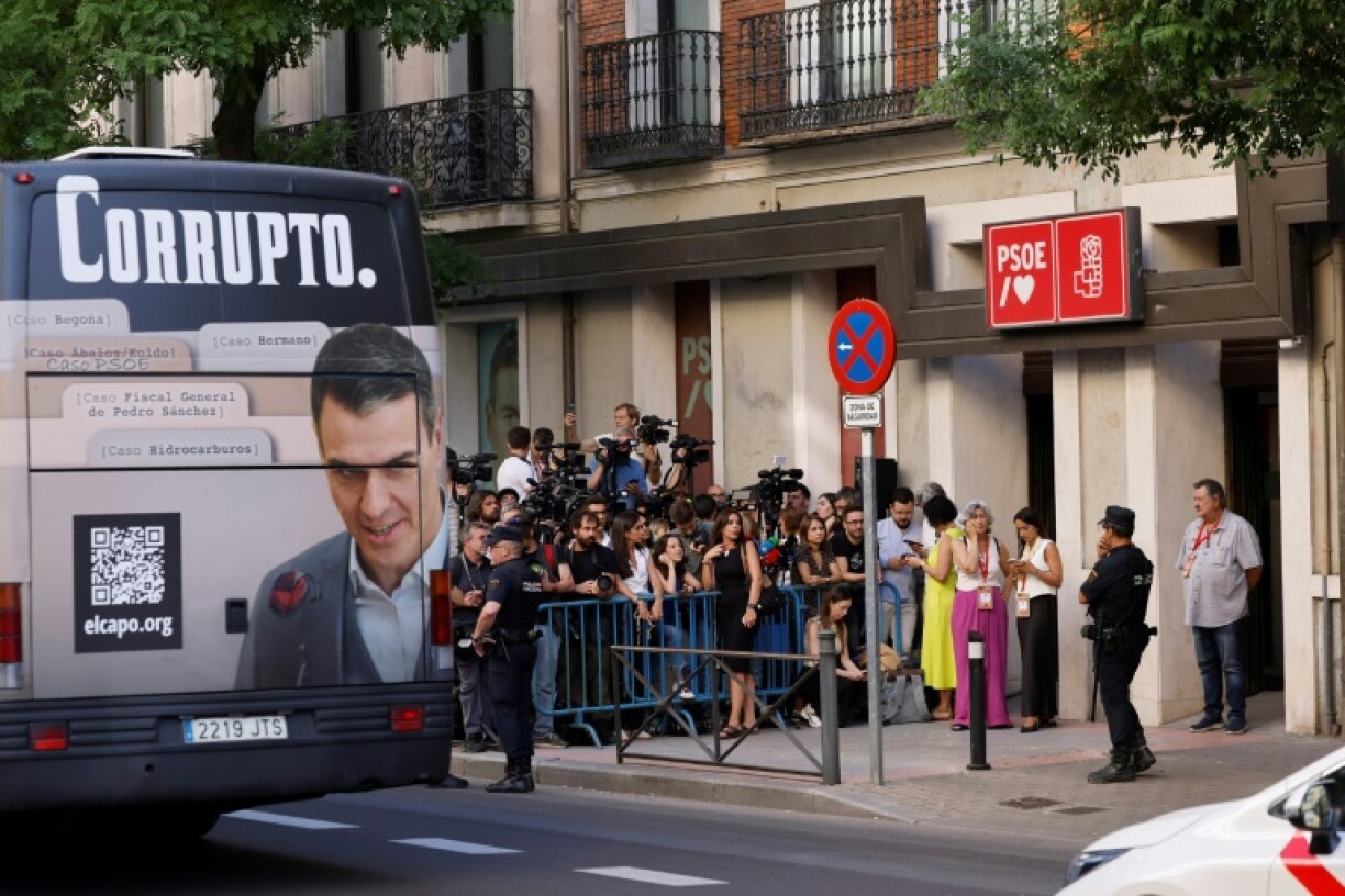 The Spanish PM, blasted as 'corrupt' in this Madrid bus ad, is facing the worst crisis of his seven years in power
