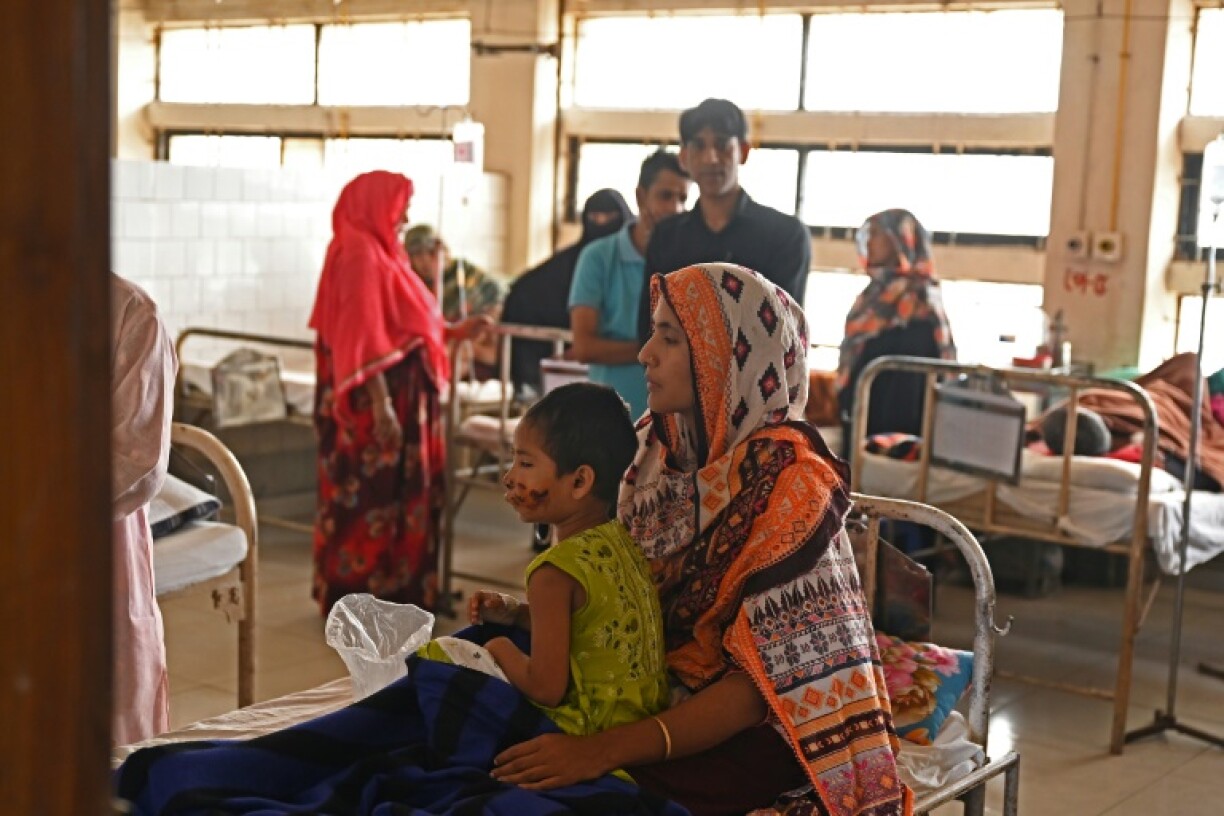 Musqan rests in her mother's lap at the Dhaka hospital where she is being treated after a jackal attack