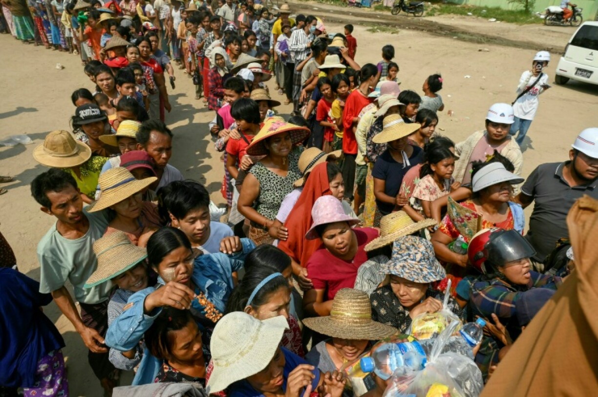 People line up for food being distributed in Sagaing, a week after the deadly earthquake