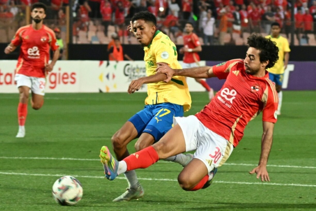 Mamelodi Sundowns forward Tashreeq Matthews (L) and Al Ahly defender Mohamed Hany fight for the ball during the CAF Champions League semi-final in Cairo