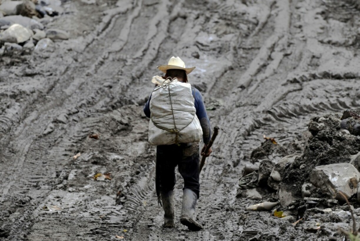 A man wades through mud after severe flooding in the Mexican town of Huehuetla in Hidalgo state