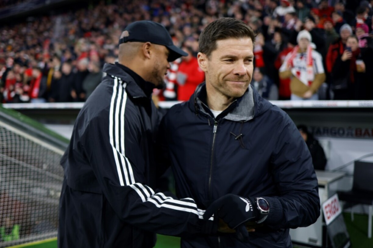 Bayern Munich coach Vincent Kompany (L) greets Bayer Leverkusen coach Xabi Alonso. The two clubs will duke it out on Saturday.