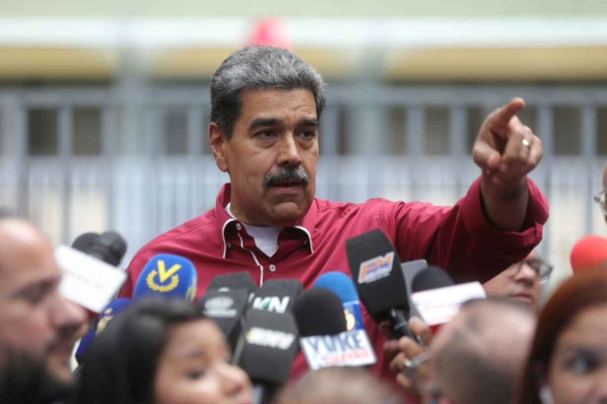 Cette photo fournie par la présidence vénézuélienne montre le président vénézuélien Nicolas Maduro s'adressant à la presse devant un bureau de vote lors des élections régionales, à Caracas, le 25 mai 2025