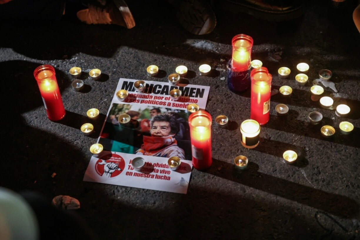 A flyer with an image of Maricarmen Abascal, the 87-year-old pensioner whose eviction triggered nationwide protests over Spain's chronic housing crisis and a political debate that culminated in early elections, is seen at an impromptu protest vigil after she died in hospital in Madrid on October 7, 2026. Abascal became a symbol of Spain's housing market on September 23 when she was evicted from her life-long Madrid home on a stretcher after the real estate firm that owned the apartment drastically hiked the rent.