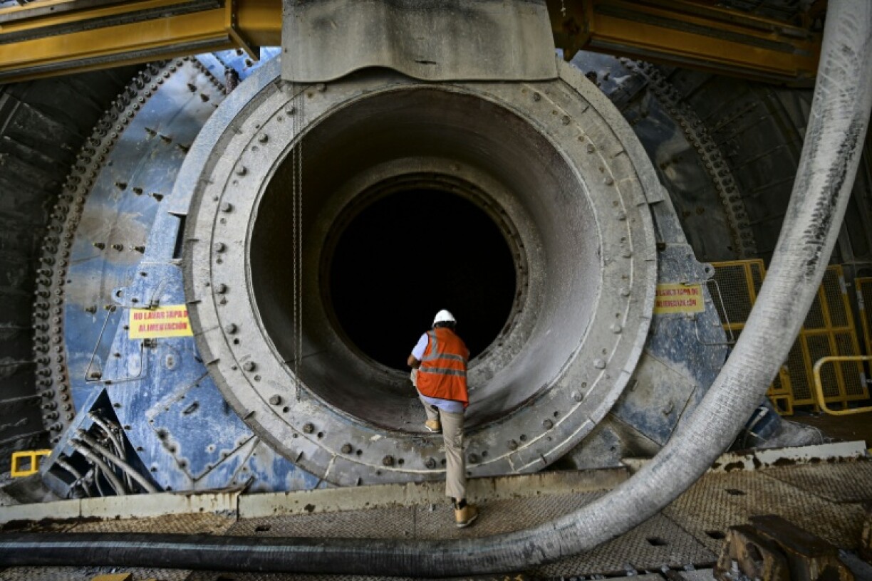 An employee inspects heavy machinery that sits unused at the Cobre Panama copper mine