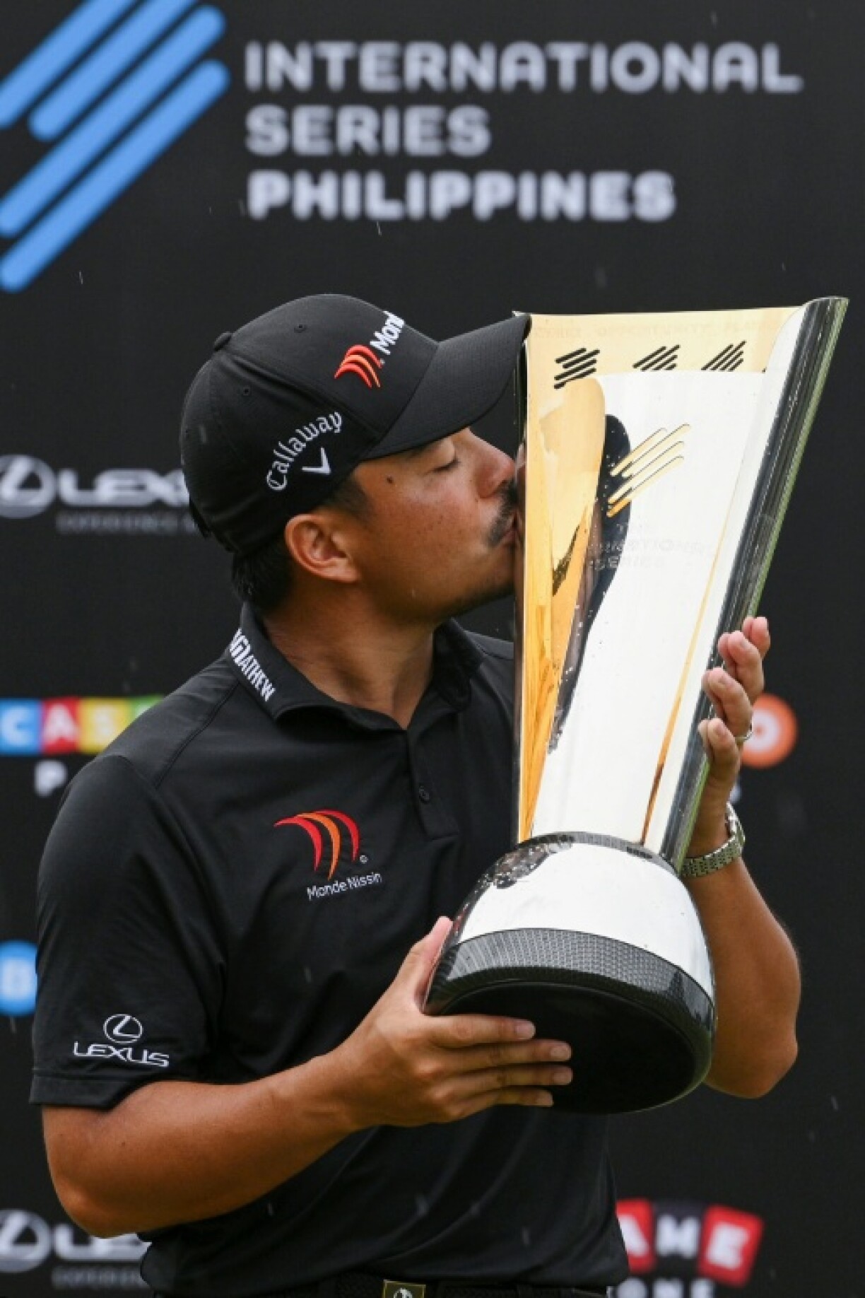 Philippines' Miguel Tabuena kisses the trophy after winning the International Series Philippines