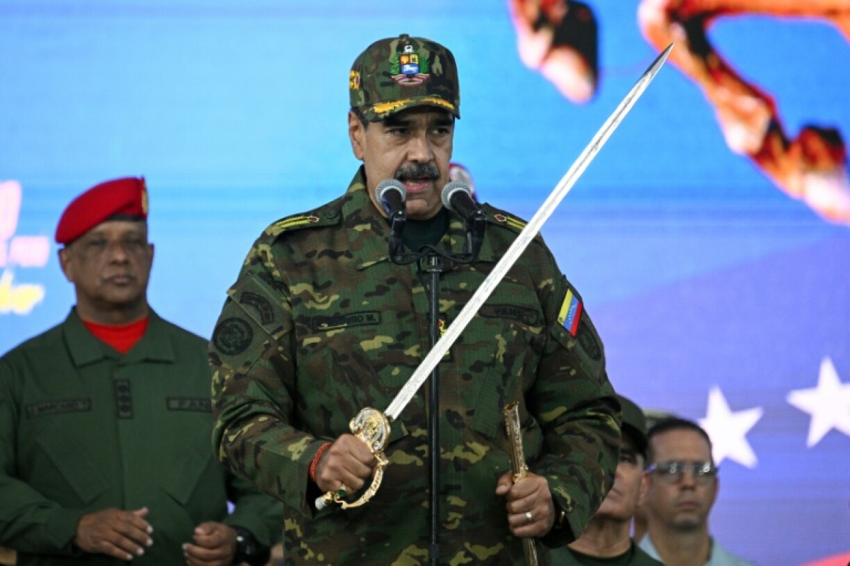 Venezuela's President Nicolas Maduro delivers a speech in Caracas while holding the independence hero Simon Bolivar's sword
