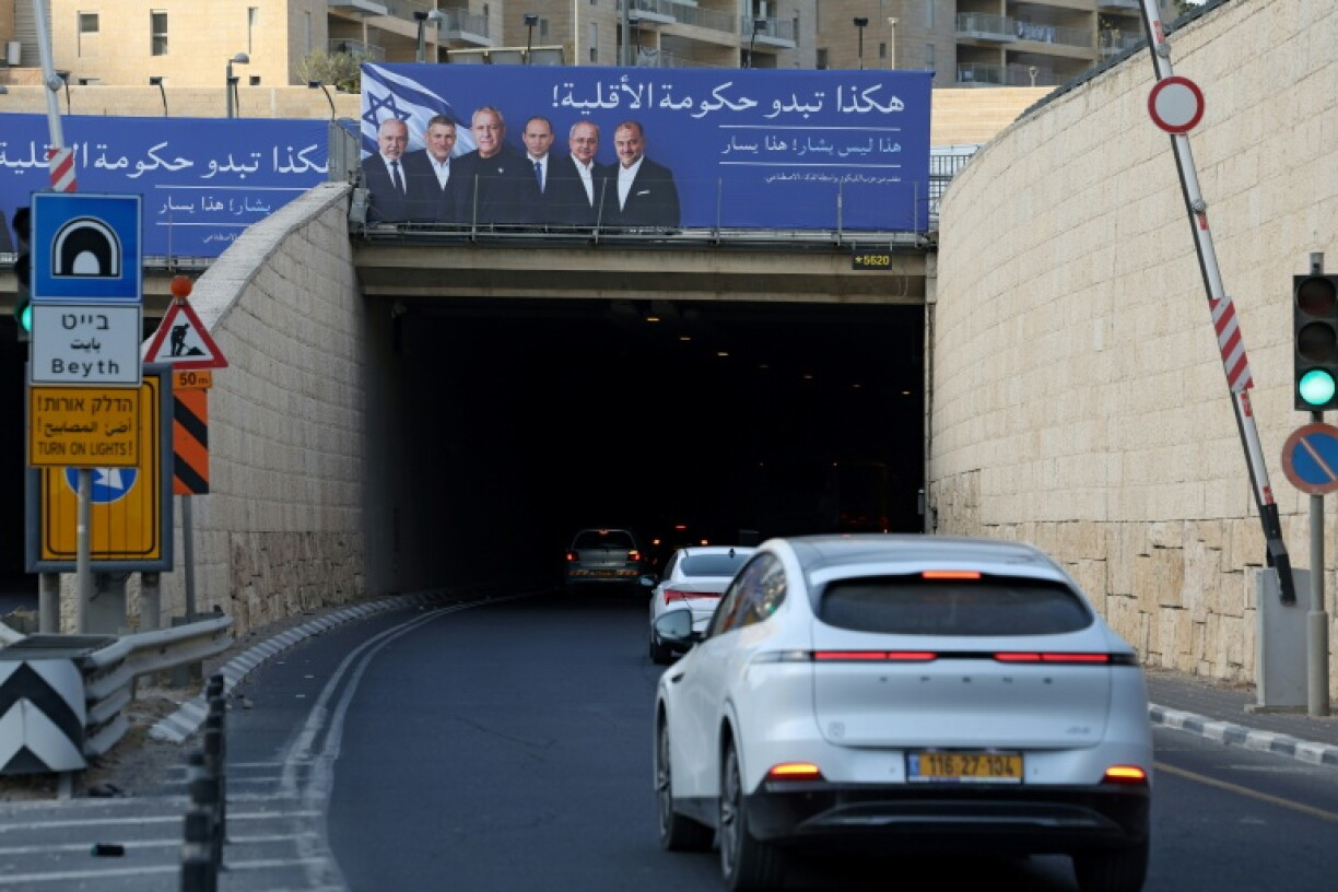 An election campaign billboard in Jerusalem attacks Israeli opposition politicians with an Arabic caption that reads, "This is what a minority government looks like!"