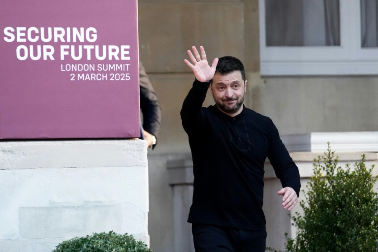 Ukraine's President Volodymyr Zelensky waves while attending a summit at Lancaster House in central London