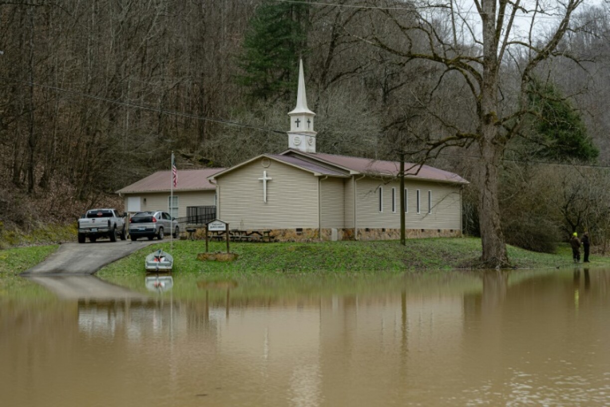 Residents stand on the grounds of Confluence Baptist Church in a heavily flooded neighborhood on February 18, 2025 in Leslie County, Kentucky. Severe weather events in February claimed the lives of 22 people in the state