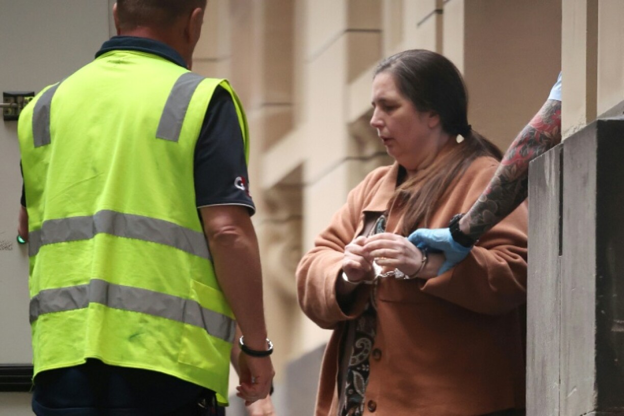 Convicted murderer Erin Patterson is escorted out of the Supreme Court of Victoria following a pre-sentencing hearing in Melbourne