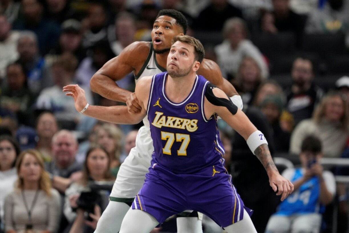 Luka Doncic of the Los Angeles Lakers defends Giannis Antetokounmpo in the Lakers' NBA victory over the Milwaukee Bucks