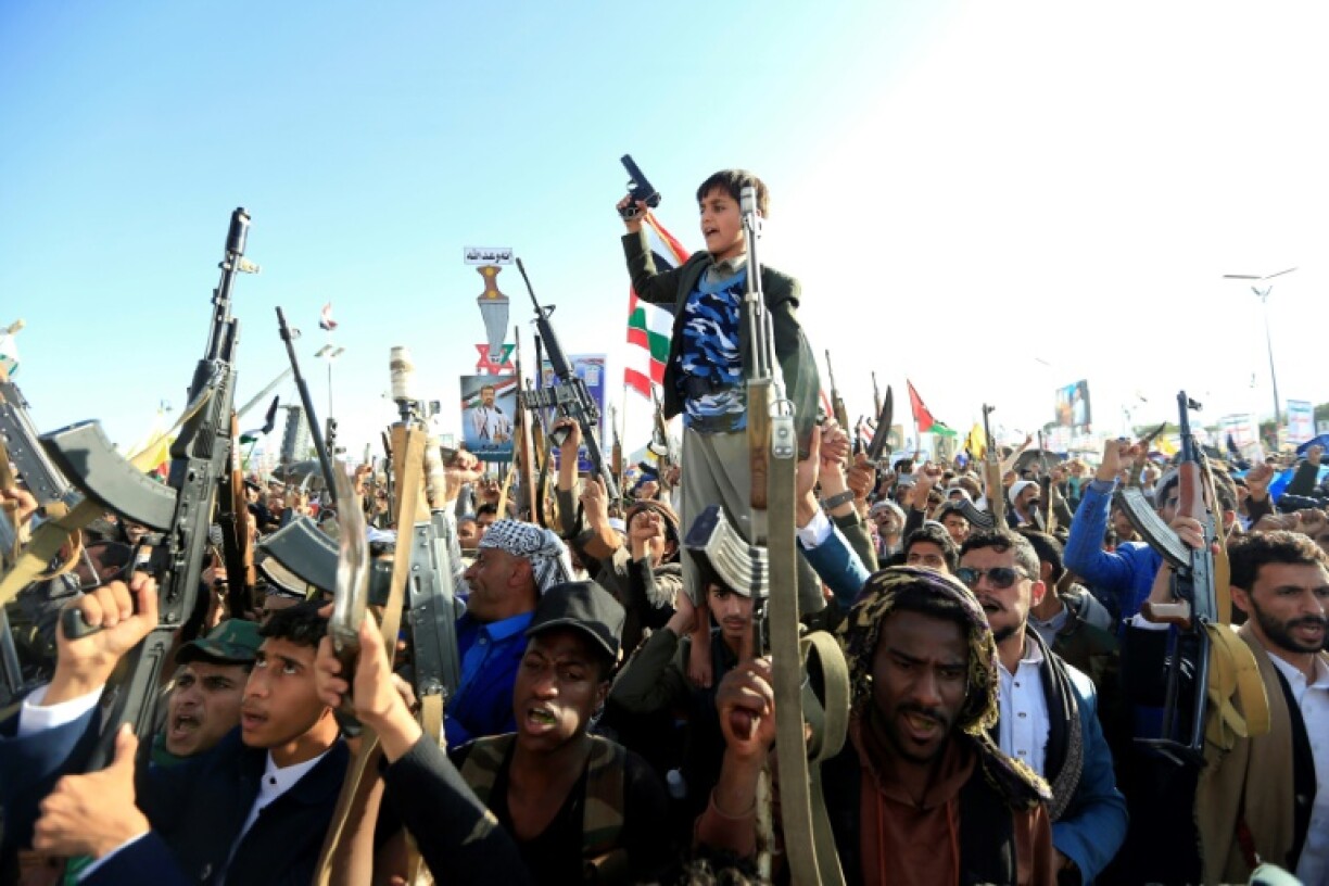 Yemenis brandish rifles and chant slogans during regular anti-Israel demonstrations in Sanaa